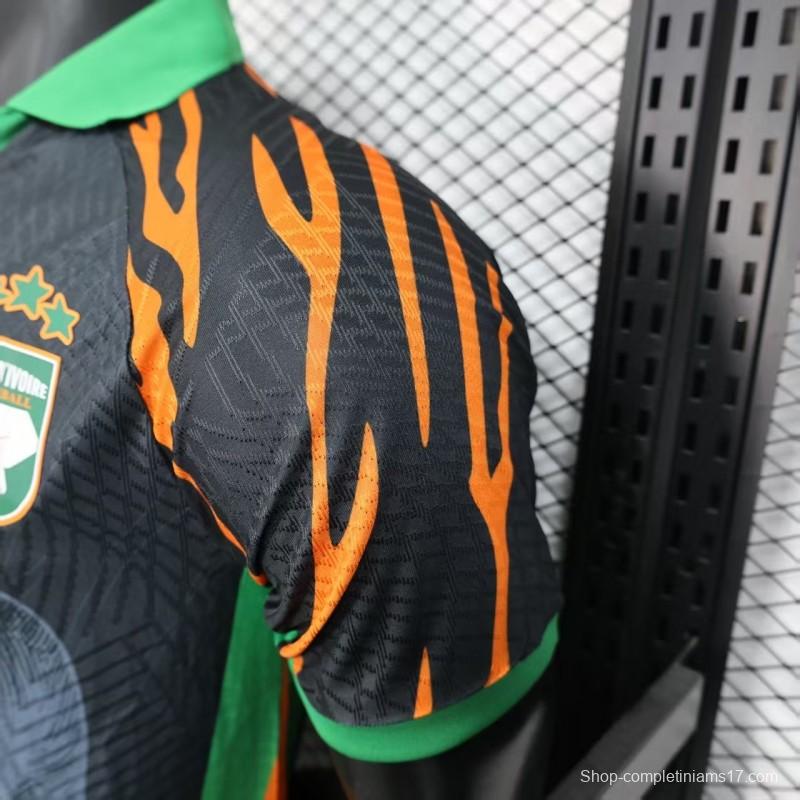 Player Version 2025 Ivory Coast Black with Elephant Graphic and Orange Stripes Jersey